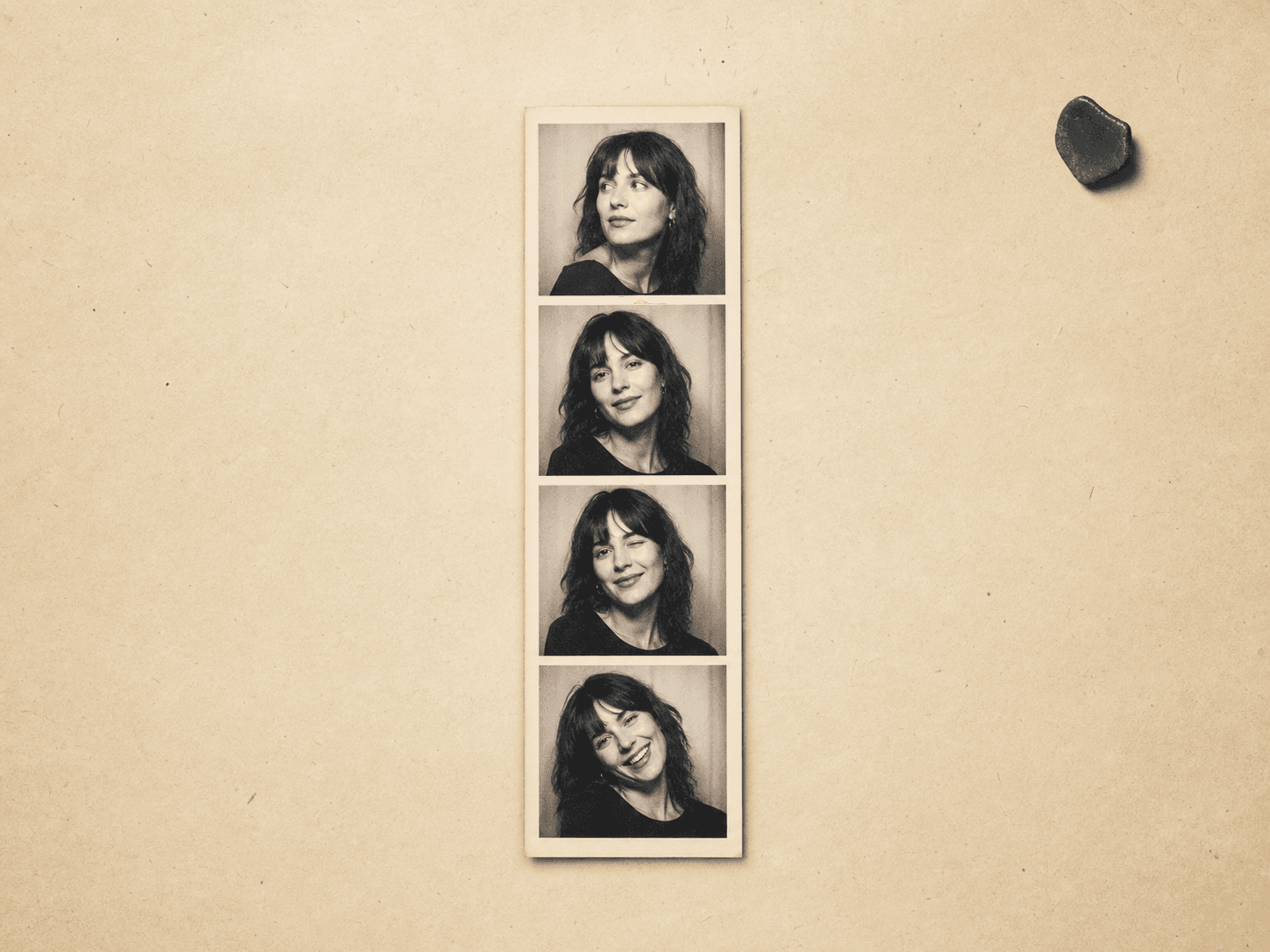 Complete black and white vintage photo booth strip on cream paper